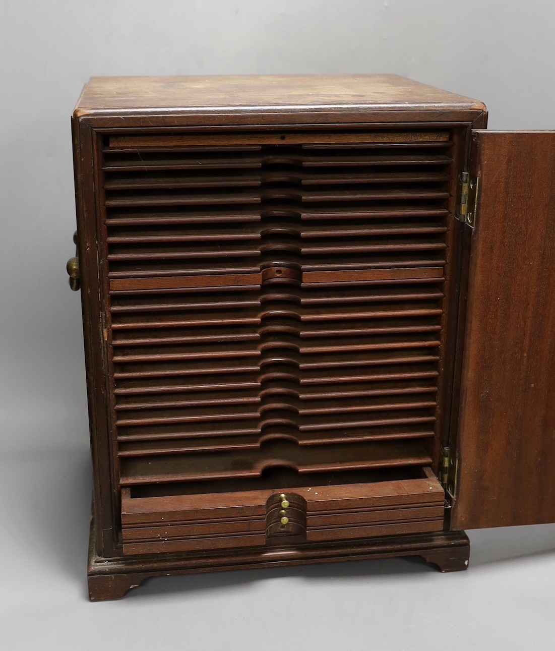 A 19th century mahogany coin collector’s cabinet, lacking trays. 39.5cm high, 32cm wide, 28cm deep